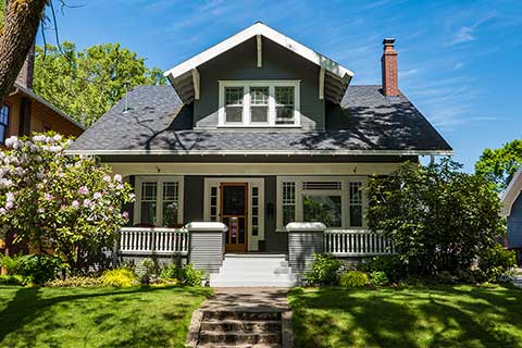 a house with a lawn and trees