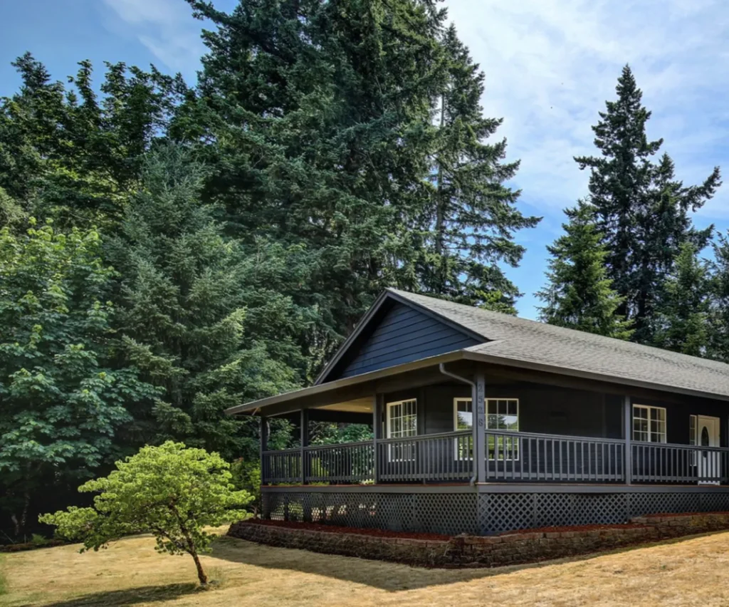 House surrounded by lush trees, showcasing a well-maintained exterior, ideal for quick cash sales by Portland Cash Buyers, emphasizing the ease of selling homes as-is.