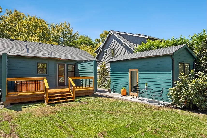 Blue exterior houses with wooden deck and seating area in yard, representing Portland Cash Buyers' focus on buying homes as-is for cash offers.